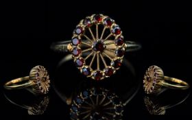 Antique Period Attractive 10ct Gold Garnet Set Wheel Designed Dress Ring, marked 10ct to shank.