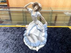 Large Nao by Lladro Figure of a Lady, sitting on a log, spring floral hat and dress with floral