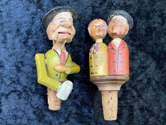 Two Antique Novelty Carved Wooden Figural Bottle Stoppers with lever operated moveable parts, one