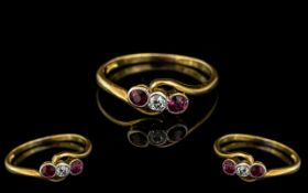 18ct Gold Antique Ruby & Diamond Ring, central diamond surround by two rubies on a twist. Hallmarked