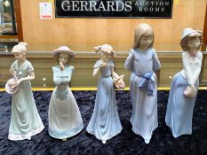 Three Nao Figures, including a 10'' figure of a girl in blue dress, a 10'' figure of a girl in a