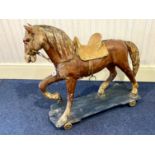 Vintage Child's Rocking Horse, on a wooden platform raised on castors,