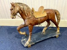 Vintage Child's Rocking Horse, on a wooden platform raised on castors,