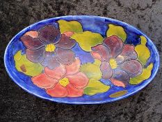 Moorcroft Oval Shaped Dish, 9'' long x 5'' wide. Hibiscus pattern, dark blue background with
