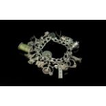 A Good Quality Vintage Sterling Silver Charm Bracelet Loaded with Over 20 Silver Charms. All