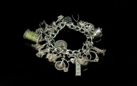 A Good Quality Vintage Sterling Silver Charm Bracelet Loaded with Over 20 Silver Charms. All