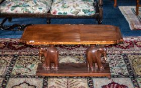 A Early 20th Century Coffee Table Shaped Rectangular Top Raised On Carved Elephant Supports With