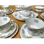 Richmond Bone China 'Blue Poppy' Tea Service, comprising a milk jug, two sugar bowls, seven teacups,