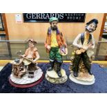 Three Capo di Monte Figures, comprising a man sharpening tools, a violin player and a fish seller,