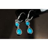 Turquoise Double Drop Earrings, each earring comprising a pear cut cabochon turquoise below a