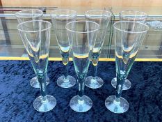 Contemporary Set of Seven Hand Blown Champagne Flutes, each with a hint of green colour; a stylish