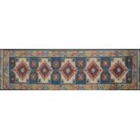 Caucasian pattern runner and two small rugs,