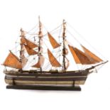 Wooden model of three-masted brig; a set of small metal model ships; and a set of metal scout models