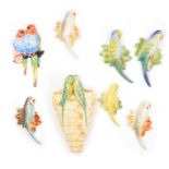 Kensington Ware budgerigar wall pocket, and Solian Ware and other budgerigar wall plaques.