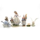 Seven Lladro figurines, two Nao swans and an Aynsley table decoration.