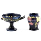 A Moorcroft Pottery vase, 'Wisteria pattern, and twin-handled pedestal bowl, 'Pansy' pattern.
