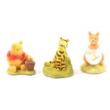 Collection of Winnie the Pooh related figurines and collectibles