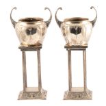 WMF, a pair of Art Nouveau silvered metal ornamental urns on stands