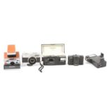 Four vintage cameras, including Polaroid SX-70 land camera