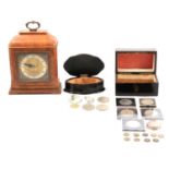An Elliott walnut mantle clock, ebony box, another wooden box and commemorative crowns.
