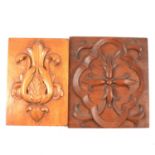 Two carved wooden plaques