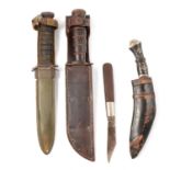 Two American Army combat knives, a kukri knife, and another.