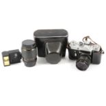 Collection of cameras including a Pentax Super; Zenit-E; and Comet S; some accessories.