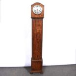 Two oak-cased grandmother clocks