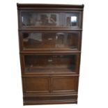 Oak four-height sectional bookcase, labelled Globe Wernicke,