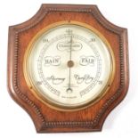 Oak cased aneroid barometer and an oak framed wall mirror,