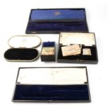 Collection of leather-covered silver boxes, and other cases.