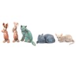 Four cats figurines and two hare figurines.