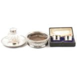 Georgian silver bottle coaster, a silver and glass inkstand,and pair of napkin rings