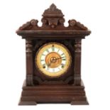 American stained wood automatic alarm shelf clock by Ansonia Clock Co,