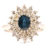 A sapphire and diamond oval cluster ring.