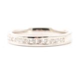 A diamond half eternity ring.