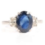 A sapphire and diamond three stone ring.