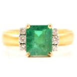 An emerald and diamond ring.