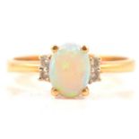 An opal and diamond dress ring.