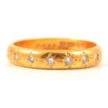 A diamond three quarter eternity ring in 22 carat yellow gold.