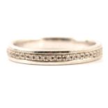 A diamond set half eternity/wedding ring.