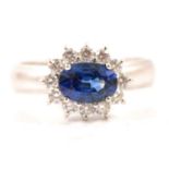 A sapphire and diamond oval cluster ring.