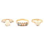 Three opal dress rings.