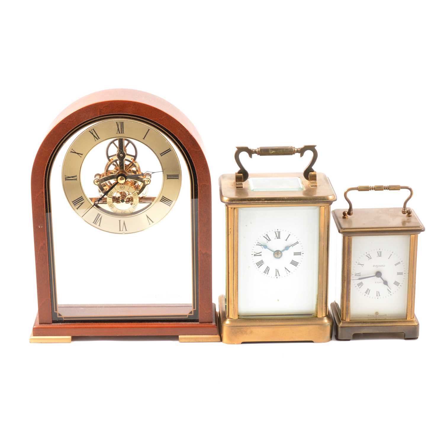 Two brass carriage clocks and a modern mantel clock.