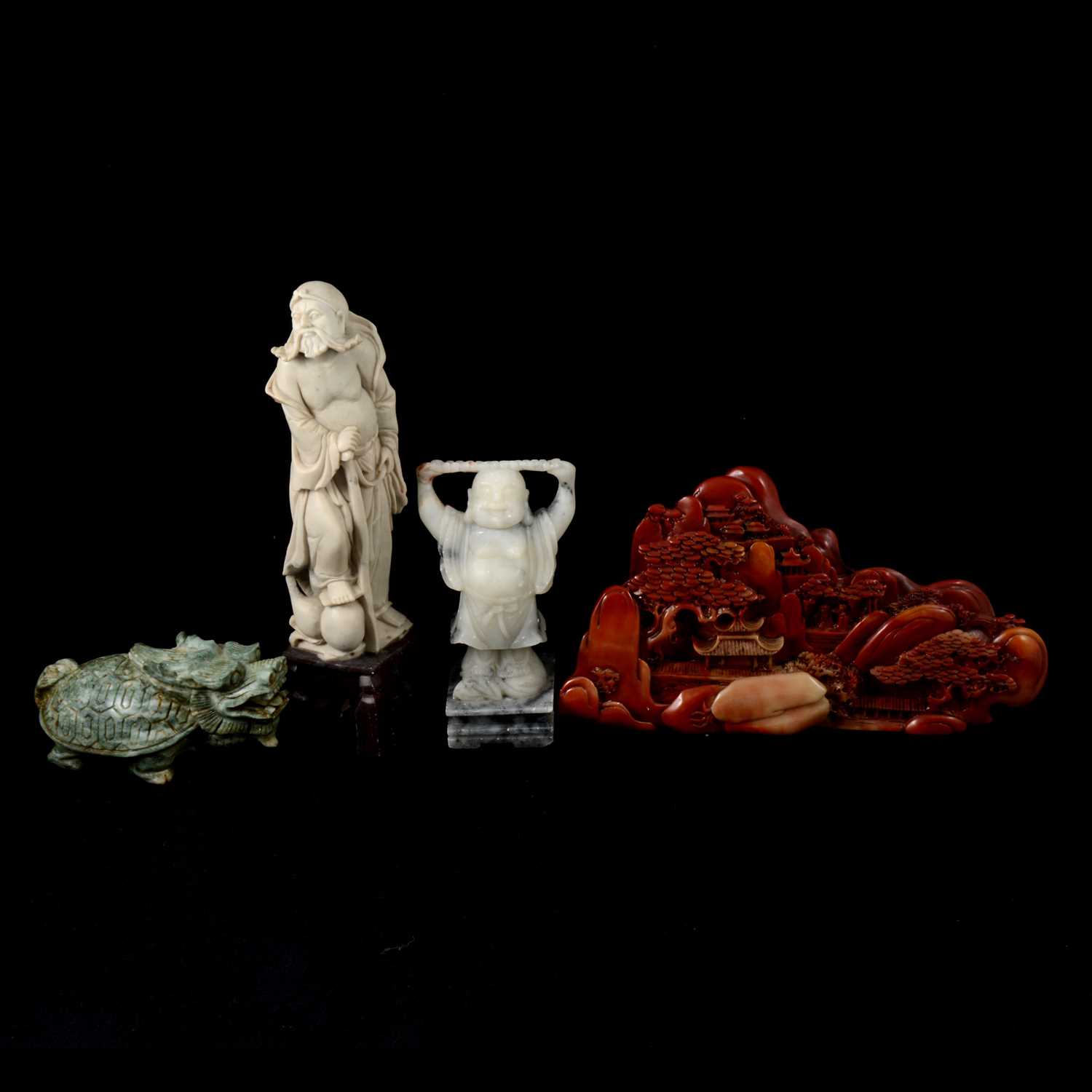 Four Chinese carved figures, a lion, a landscape