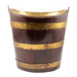 A George III coopered mahogany oval peat bucket