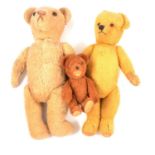 Three mid-century jointed teddy bears, smaller brown bear is straw filled,