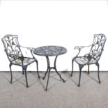 Black wrought metal patio table and two armchairs