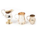 Small silver cup, maker's mark rubbed, London 1782, and two silver cream jugs.