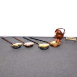 Four copper/brass warming pans; copper scuttle and brass trivet; candlesticks, pans.